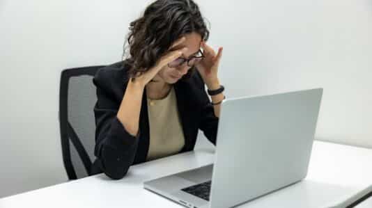 Tired Young Female Employee Feeling Stressed and Burnout from Computer Work