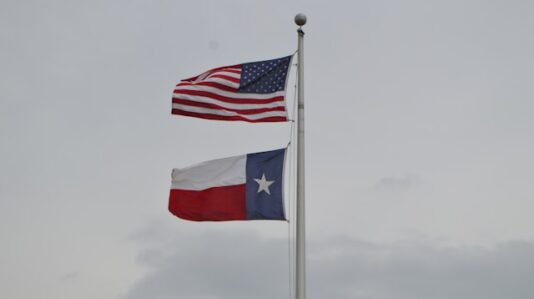 2 flags raised up together