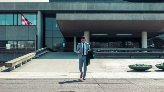 a man using a mobile phone while walking