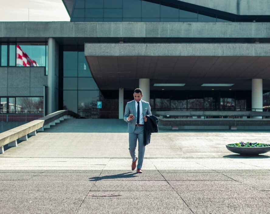 a man using a mobile phone while walking