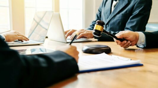 people's hands working at the court table