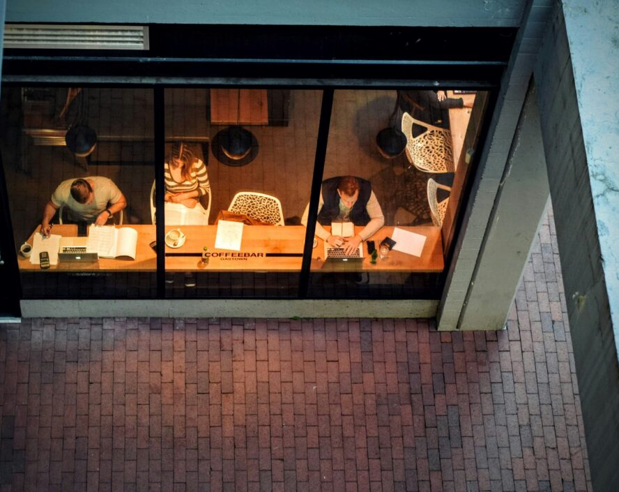 top view shot of three people sitting and reading