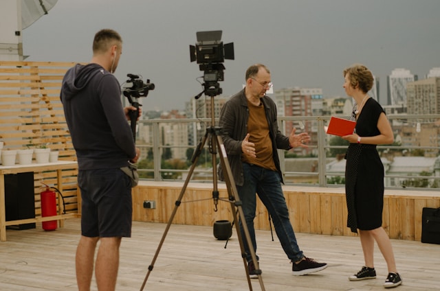 two actors talking with a camera man