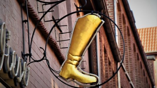 a signage with a golden boot