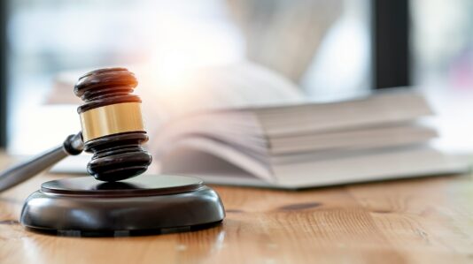 a wooden gavel and book on a table