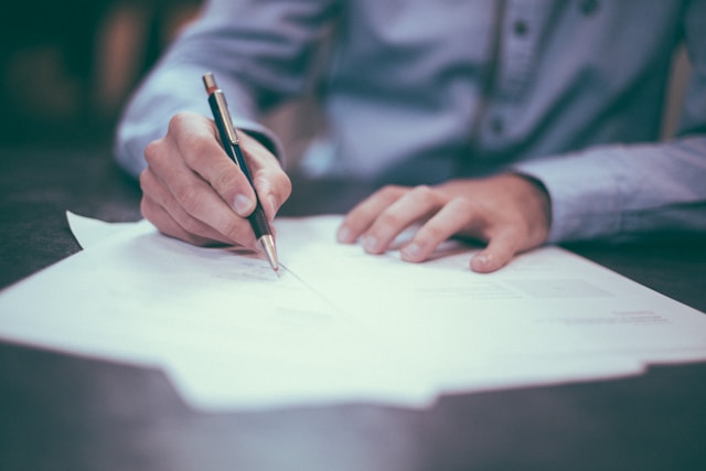 a man signing a document