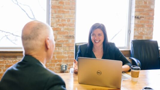 a woman with full smile interviewing a candidate