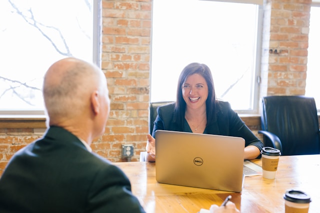 a woman with full smile interviewing a candidate